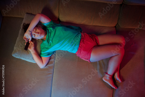 Woman suffering from mental health issues on sofa photo