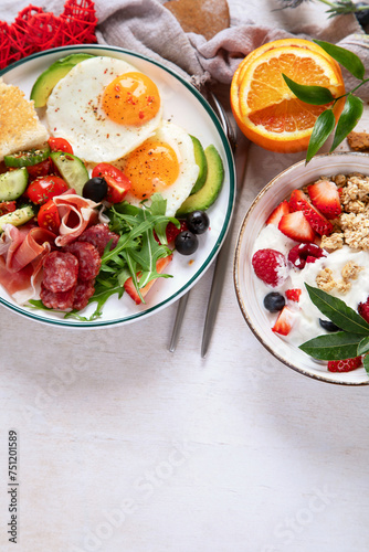 Healthy breakfast with oatmeal, berries, egg, bacon and a cup of coffee. Good morning