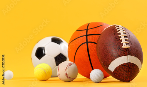 Many different sports balls on yellow background