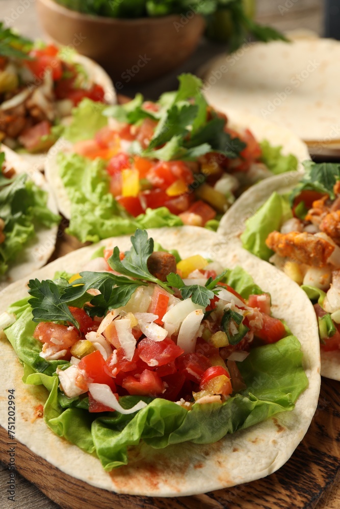 Delicious tacos with vegetables and meat on table, closeup Delicious tacos with vegetables and meat on table, closeup