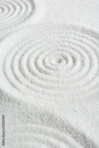 Zen rock garden. Circle patterns on white sand, closeup