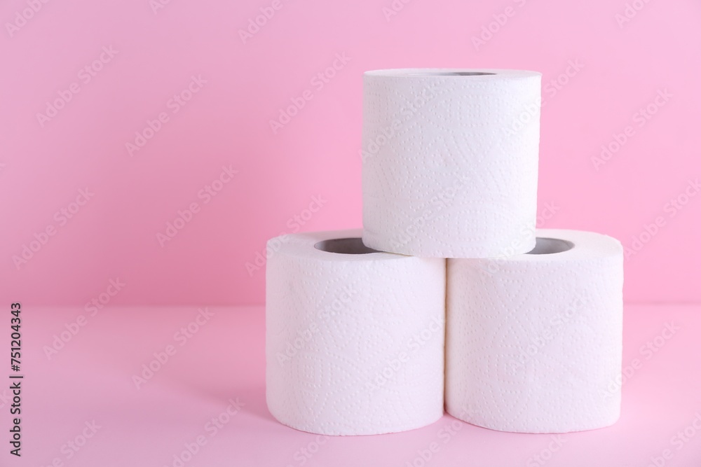 Soft toilet paper rolls on pink background, closeup. Space for text Soft toilet paper rolls on pink background, closeup. Space for text