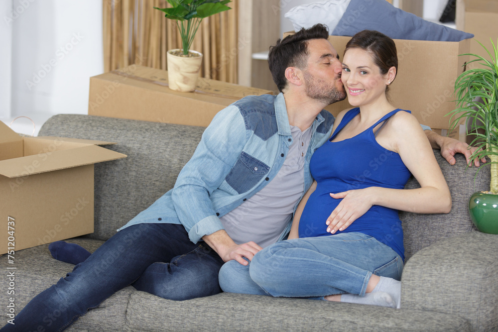 couple with pregnant woman relaxing on sofa together couple with pregnant woman relaxing on sofa together