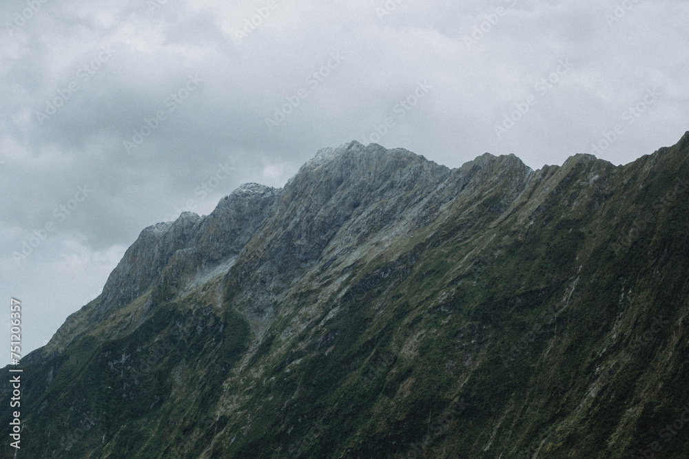 Naklejka premium Stormy cloudy sky above natural grey moody mountain peaks