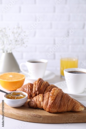 Croissants and jam on white wooden table. Tasty breakfast