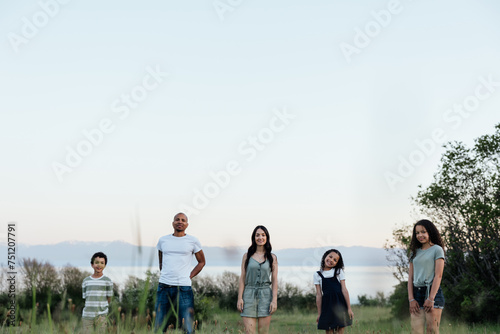  A wide family shot in long grass after sundown. photo
