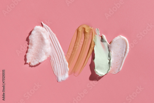 cosmetic smears cream texture on pink background photo