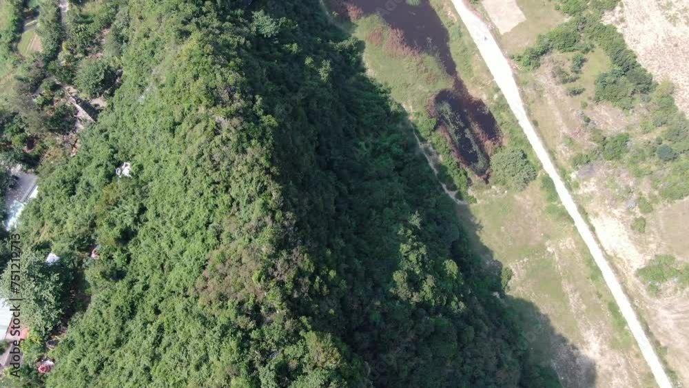 Drone aerial view in Vietnam flying over Da Nang coast city marble mountains top view road with cars on a sunny day Drone aerial view in Vietnam flying over Da Nang coast city marble mountains top view road with cars on a sunny day