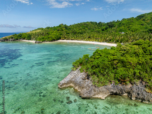 Drone view of tropical beach with corals and clear water. Cobrador Island. Romblon, Philippines.