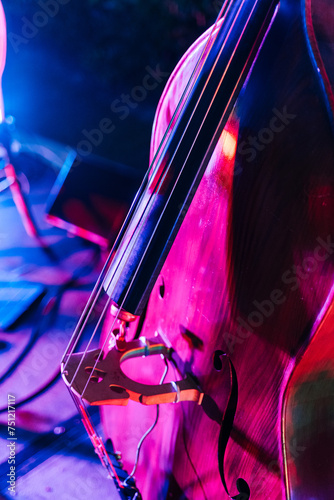 Double bass body in neon illumination during concert photo