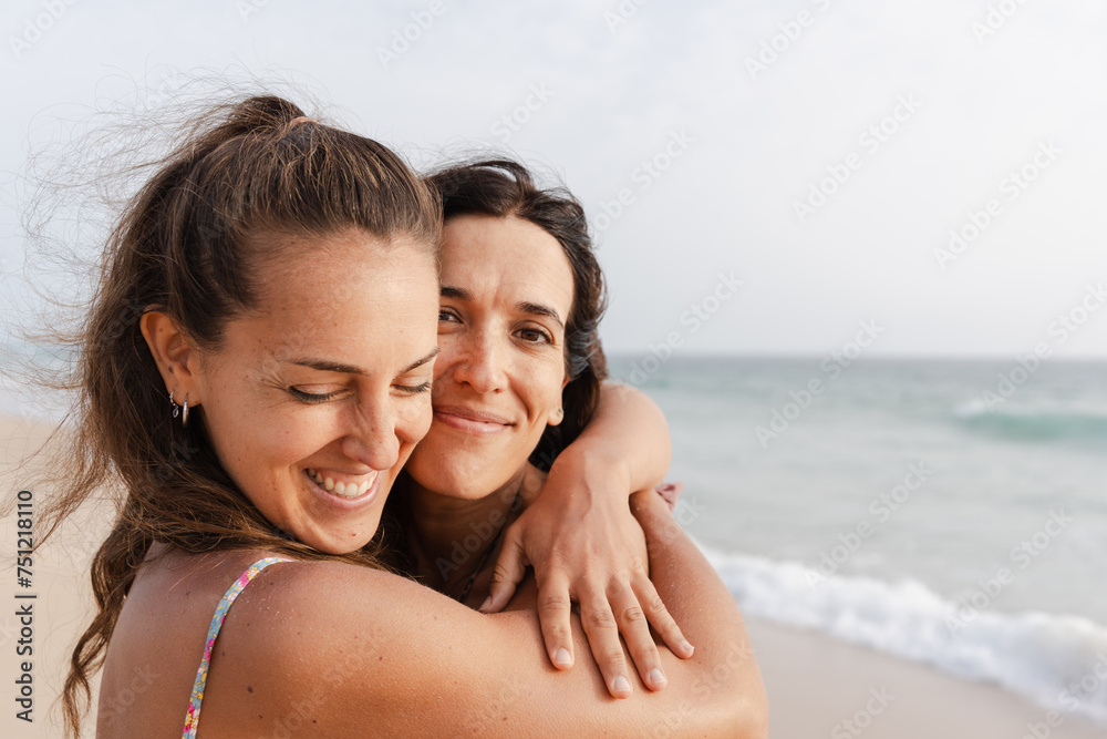 portrait of two smiling women at the beach portrait of two smiling women at the beach