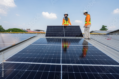 Wallpaper Mural Men technicians carrying photovoltaic solar moduls on roof of factory on the morning. Installing a Solar Cell on a Roof. Solar panels on roof. Workers installing solar cell power plant eco technology. Torontodigital.ca