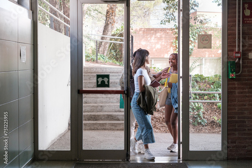 Students entering the university's door photo