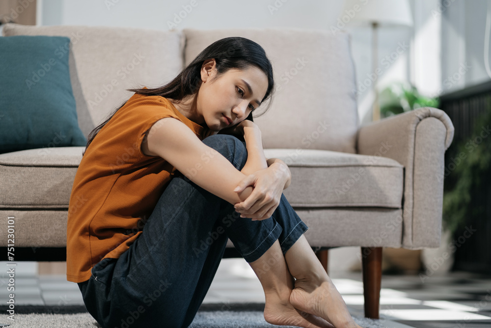 Sad and depressed young asian female sitting on the floor in the room, sad mood, feel tired, lonely and unhappy concept. Selective focus. Sad and depressed young asian female sitting on the floor in the room, sad mood, feel tired, lonely and unhappy concept. Selective focus.
