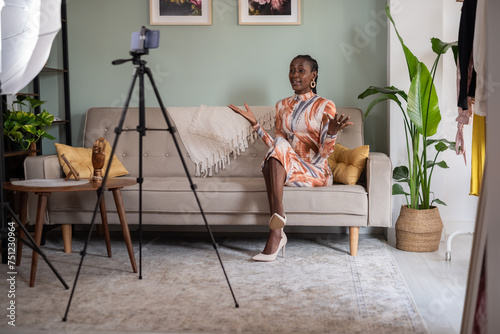 Black female influencer recording video on cellphone photo