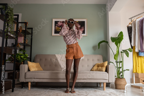 Black fashion influencer putting on sunglasses photo