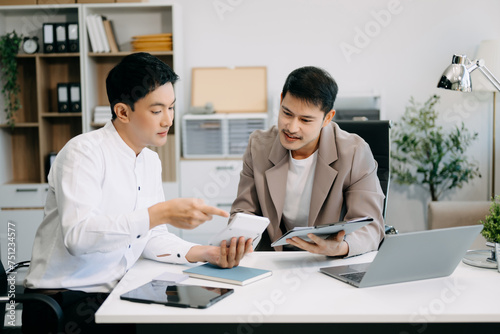 Portrait of success business people working together in office. Couple teamwork startup concept.. © Nuttapong punna