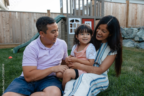 Casual portraits of a fun, loving family hanging out in the back