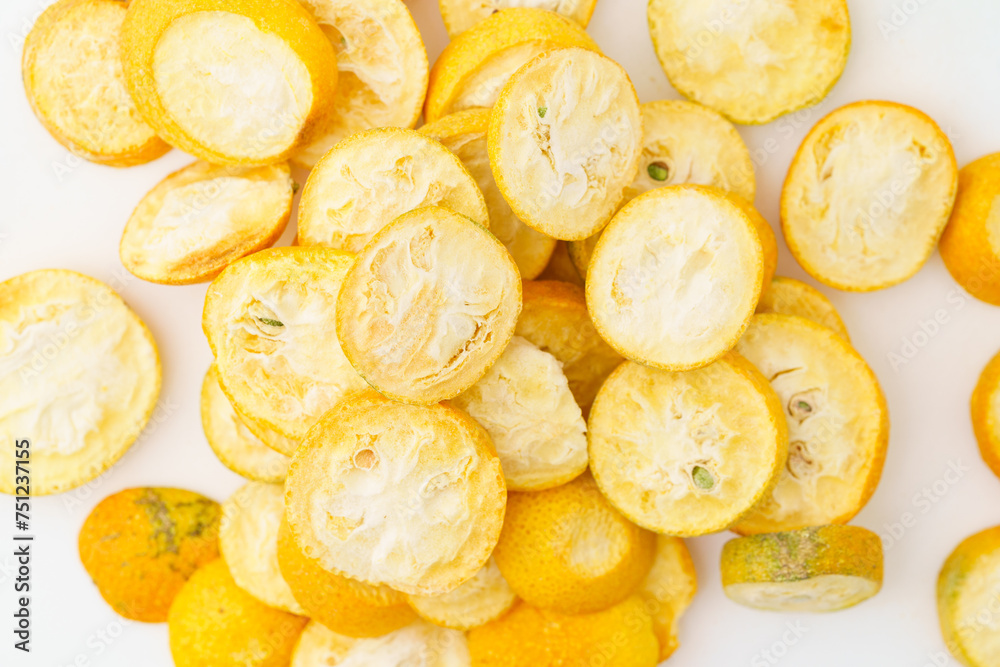 Freeze-dried kumquats on a solid color background Freeze-dried kumquats on a solid color background