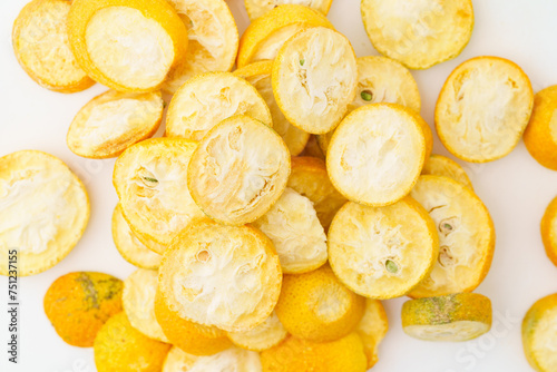 Freeze-dried kumquats on a solid color background