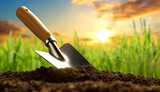 Closeup and bottom view of soil with a garden trowel and green grass on background at sunset or sunrise, gardening or agriculture concept. Generative Ai.