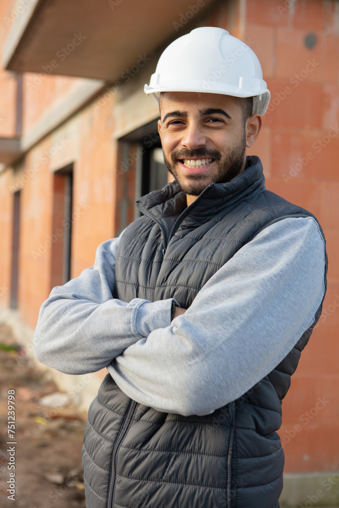 portrait of cheerful construction worker looking at camera portrait of cheerful construction worker looking at camera