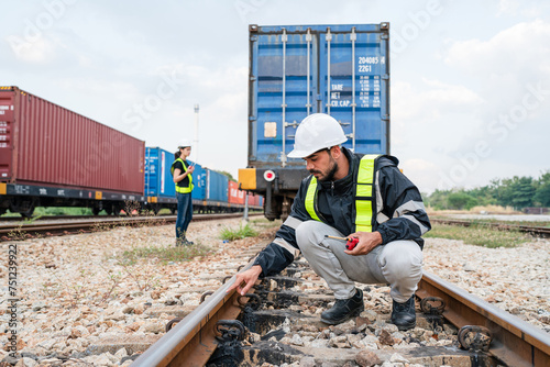 Team of engineer railway wearing safety uniform and helmet under checking train ,wheels and control system for safety transportation. Maintenance cycle concept.