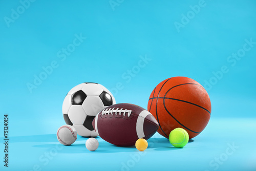 Many different sports balls on light blue background  space for text
