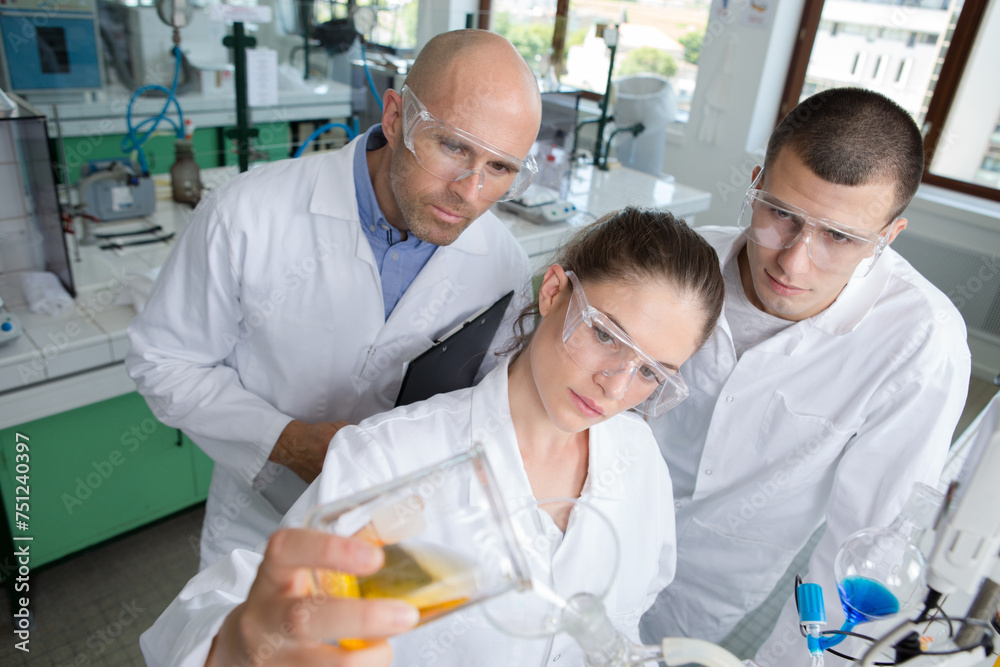 Obraz premium pensive chemist selects an essential substance for the experiment