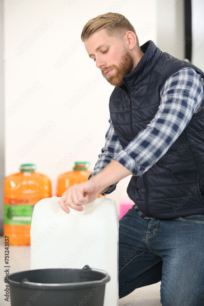 worker is transferring some liquid