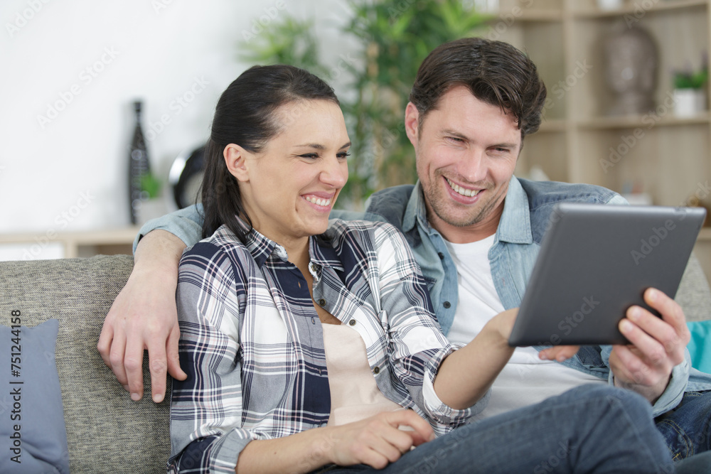 Fototapeta premium happy couple video chatting on tablet