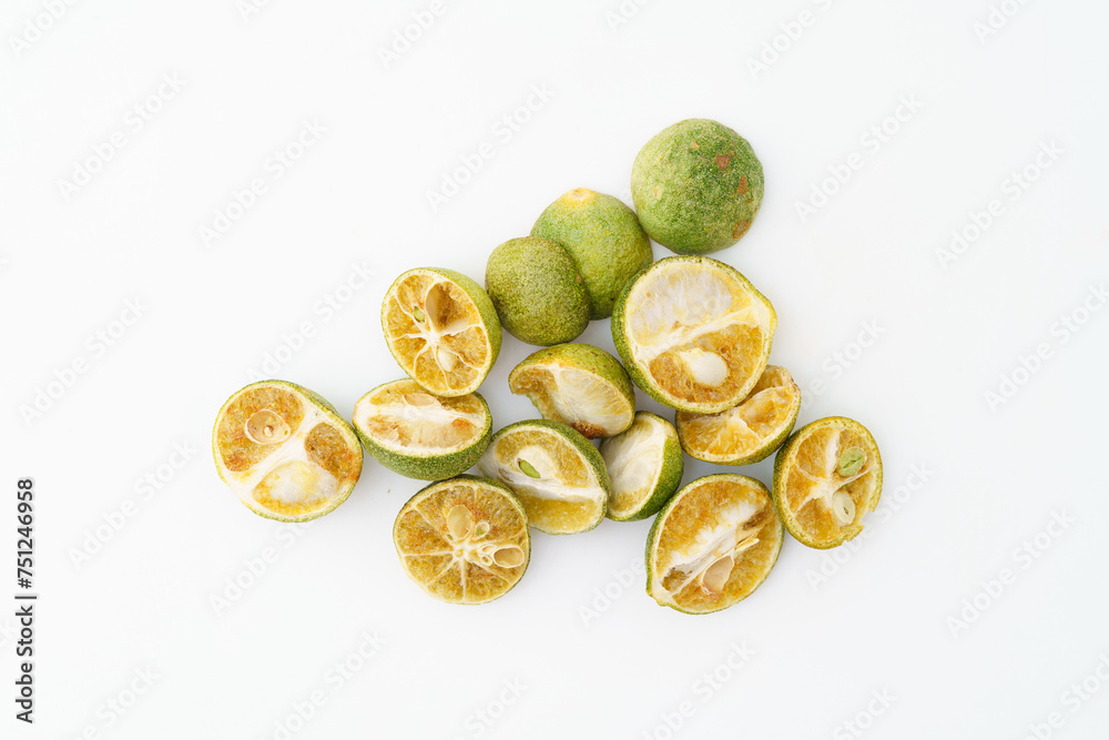 Freeze-dried small limes on a solid color background
