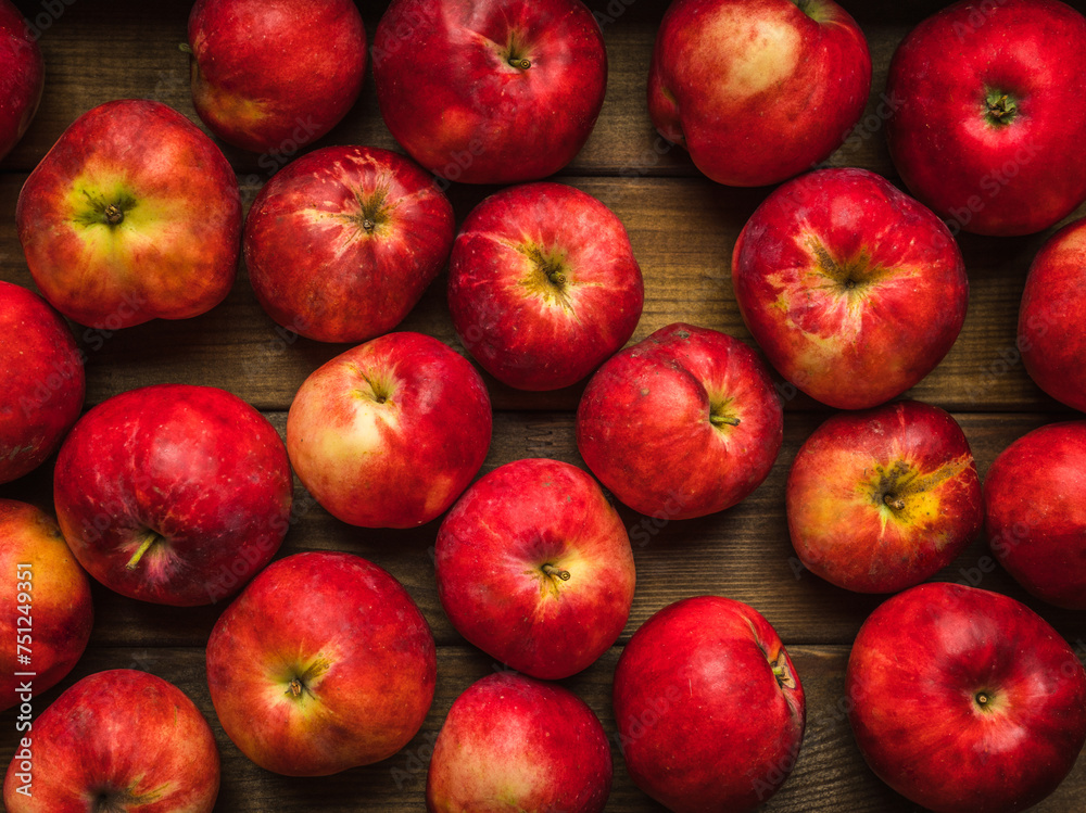 Freshly harvested red apples the wooden table. Selective focus. Shallow depth of field. Freshly harvested red apples the wooden table. Selective focus. Shallow depth of field.