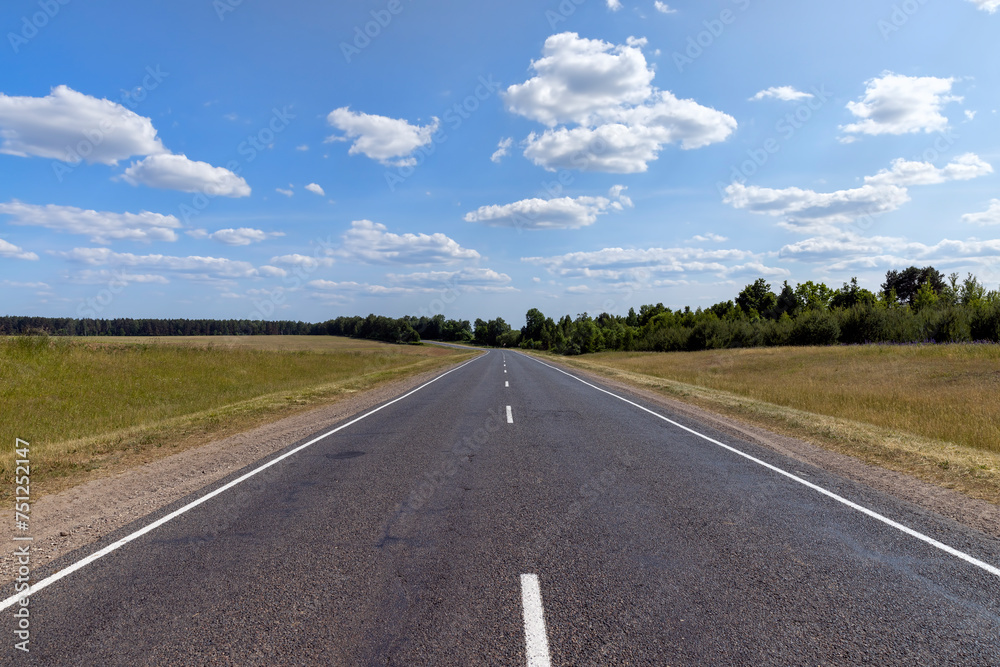 paved road along and blue sky