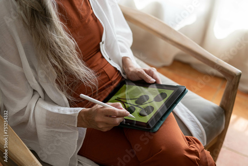 Retired woman drawing on ipad photo