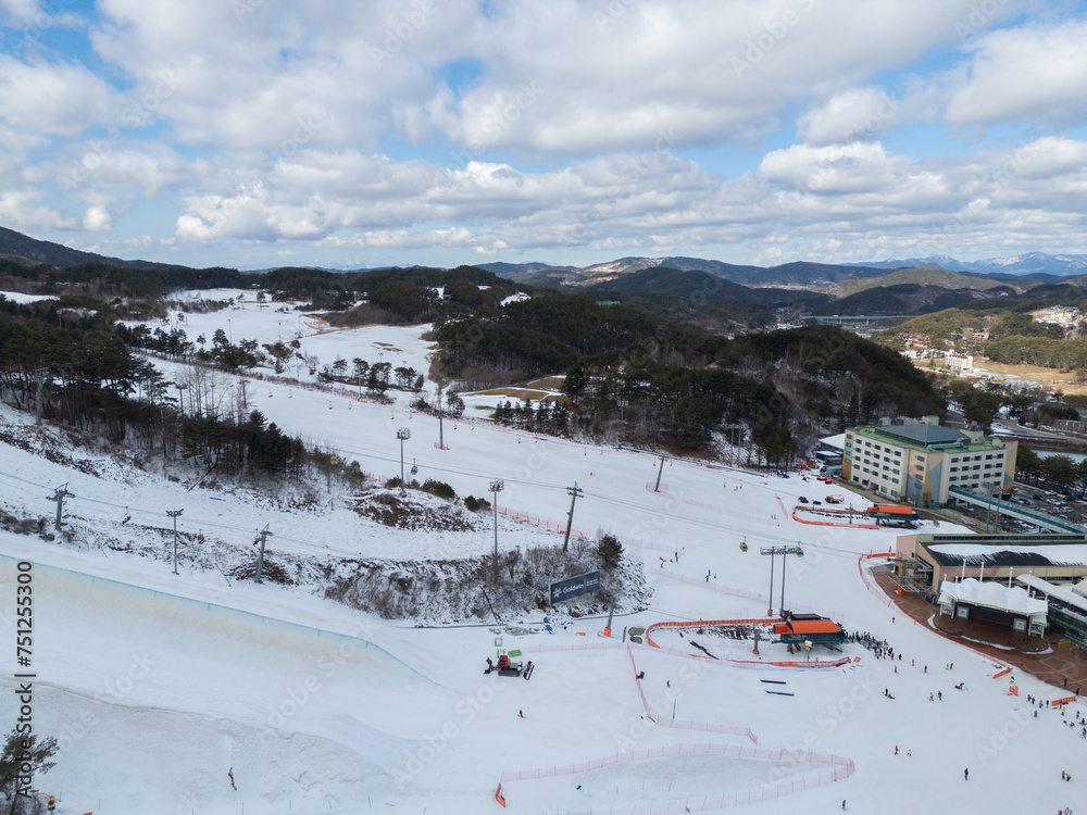 Aerial top view of Ski resort with snow mountain, sport recreation in winter season.