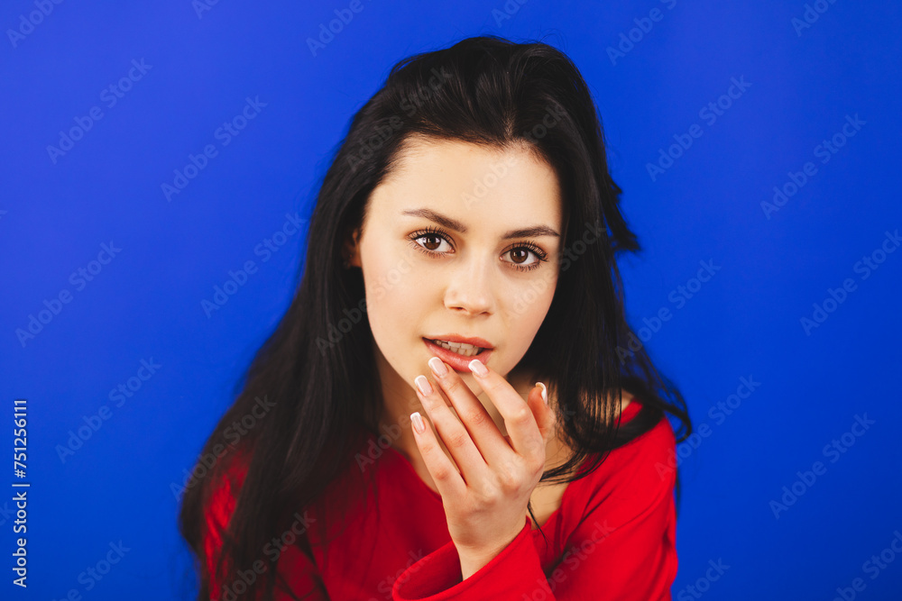 Close up photo amazing beautiful she her wondered lady attractive appearance finger touch plump lips wear red long sleeves, fix make up looking at mirror isolated blue bright background. Close up photo amazing beautiful she her wondered lady attractive appearance finger touch plump lips wear red long sleeves, fix make up looking at mirror isolated blue bright background.