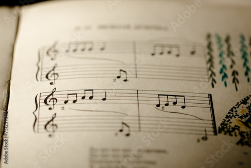 A page from a book with musical notes as a background, close-up view