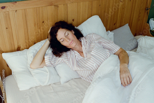 A woman resting in a bed photo