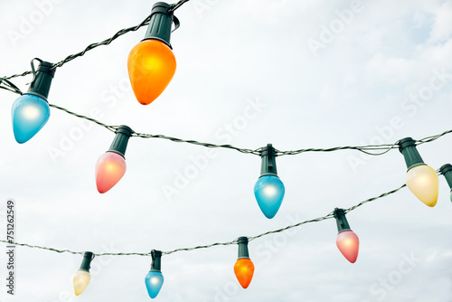 Illuminated lamps against overcast sky