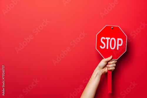 Bold Red Stop Sign Held High Against a Vivid Background Banner