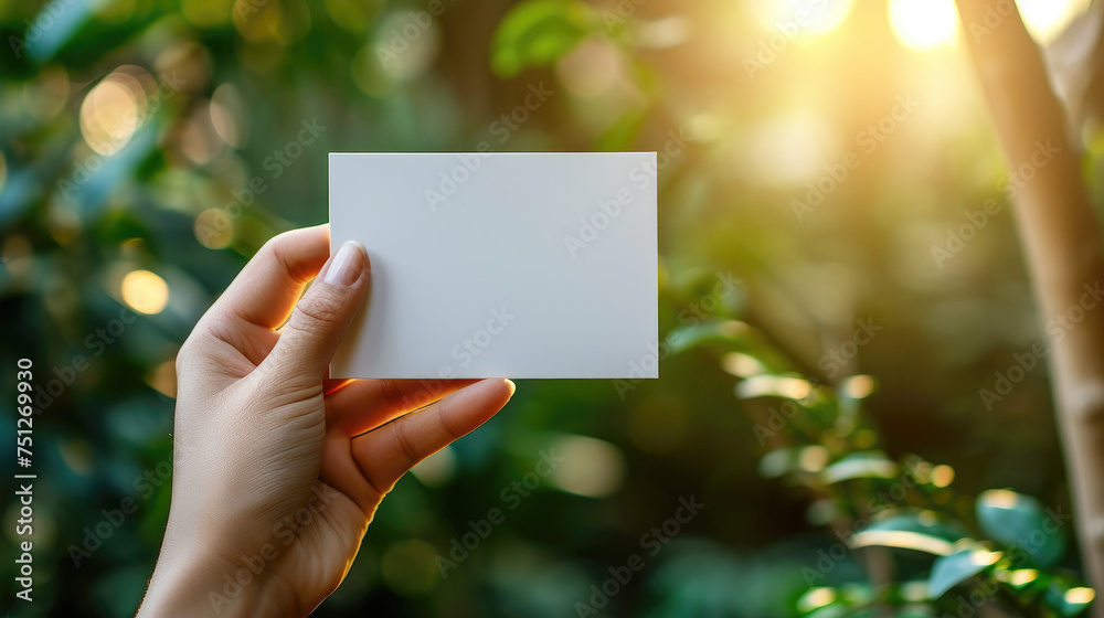 Empty Hand Holding Blank Card copy space area banner on nature forest sunlight background Empty Hand Holding Blank Card copy space area banner on nature forest sunlight background