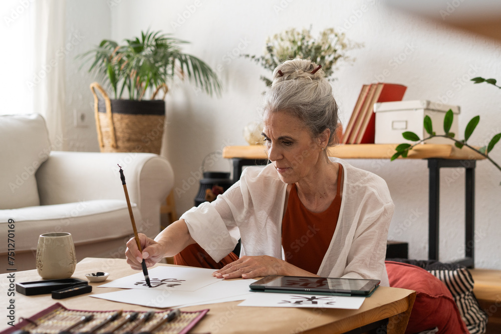 Retired woman painting sumie kanji Retired woman painting sumie kanji