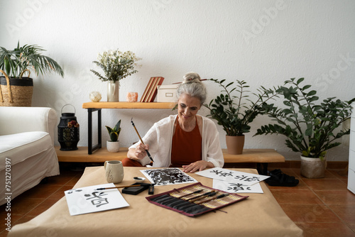 Retired woman painting sumie kanji  photo