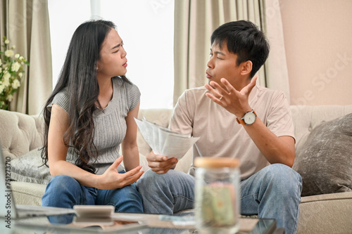 Unhappy Asian spouses are arguing about unexpected high household bills and credit card invoices. © bongkarn