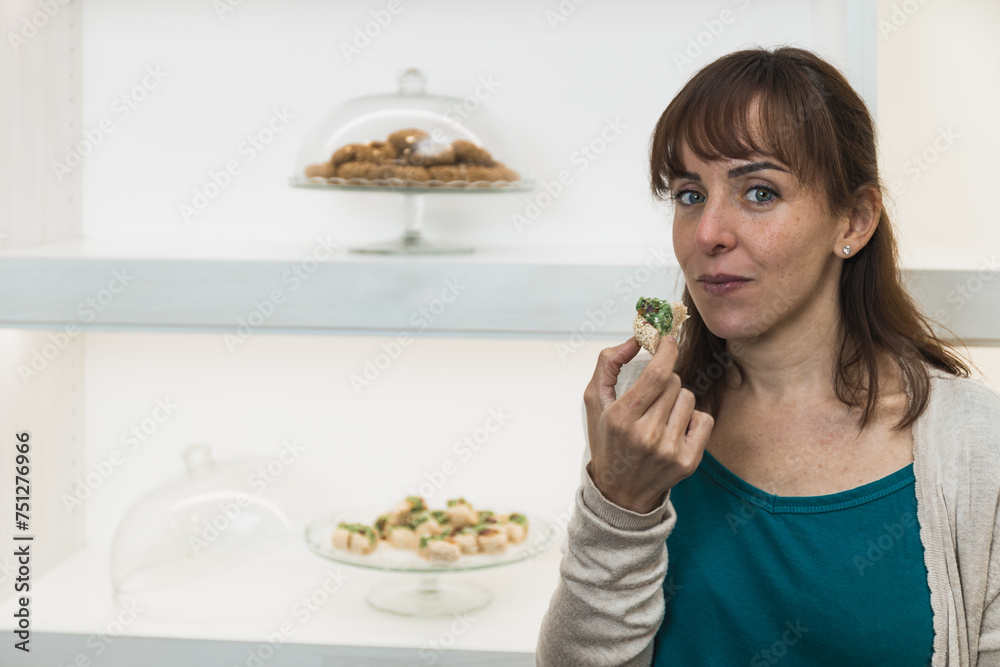 Horizontal photo customer evaluating a pistachio dessert. Copy space. Food and culture concept. Horizontal photo customer evaluating a pistachio dessert. Copy space. Food and culture concept.