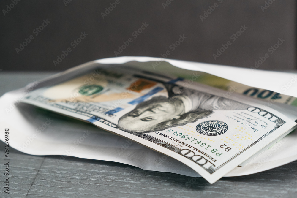 Close-up of money in an envelope. Concept of bribe, corruption, salary, earnings and financial savings. Close-up of money in an envelope. Concept of bribe, corruption, salary, earnings and financial savings.