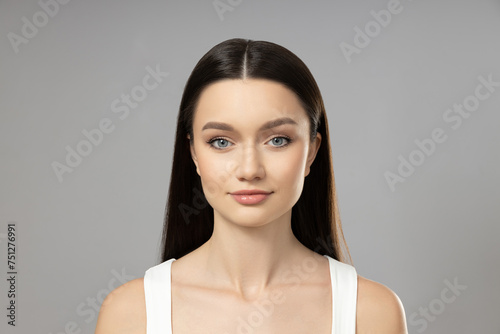 Attractive young girl on a gray background. Botox concept