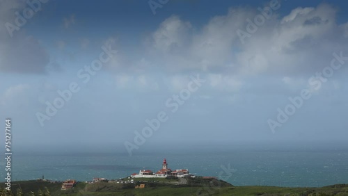 Cabo da Roca lighthouse. 4K video with the lighthouse building against Atlantic Ocean background at the most Western point from Europe during a sunny day with blue sky. Travel to Portugal photo