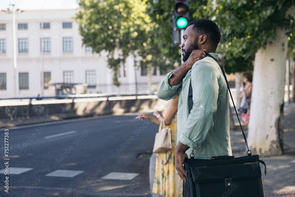A man crossing the pedestrian crossing on his way to work. A man crossing the pedestrian crossing on his way to work.
